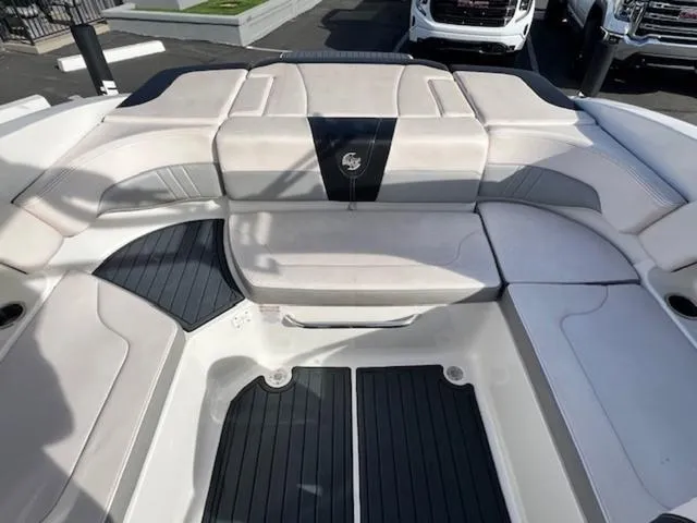 Slide: The Image of 2019 Chaparral 23 H2O Surf boat interior with cushioned seating and sleek design. - 14
