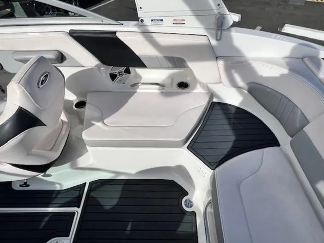 Slide: The Image of 2019 Chaparral 23 H2O Surf boat interior with white seating and black accents. - 15