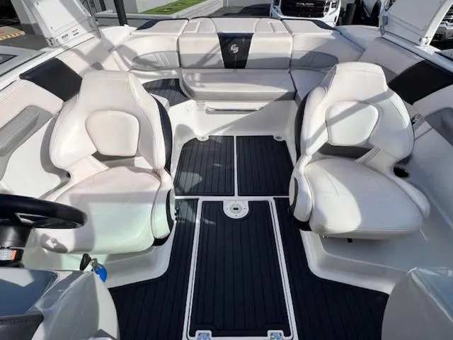 Slide: The Image of 2019 Chaparral 23 H2O Surf boat interior with white seating and black flooring. - 17