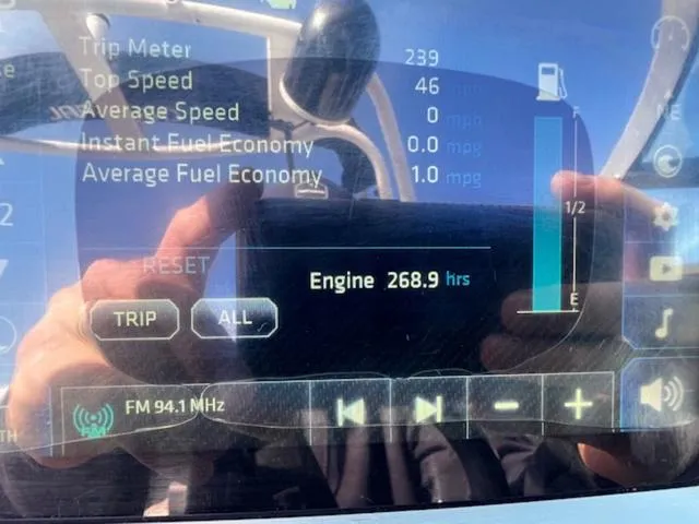 Slide: The Image of Dashboard display of a 2019 Chaparral 23 H2O Surf showing trip and engine data. - 18