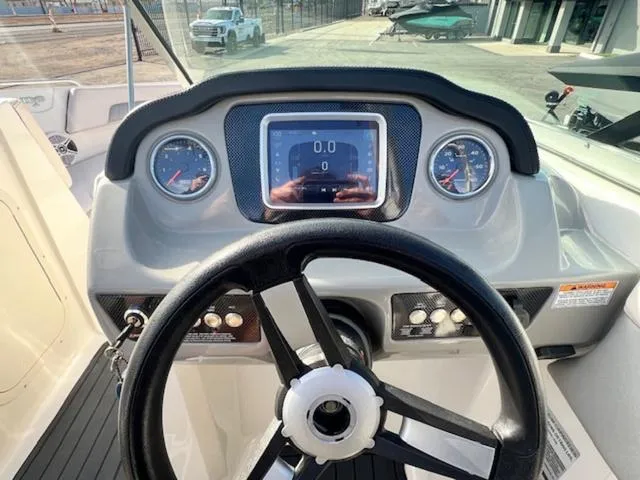 Slide: The Image of 2019 Chaparral 23 H2O Surf boat dashboard with steering wheel and digital display. - 19