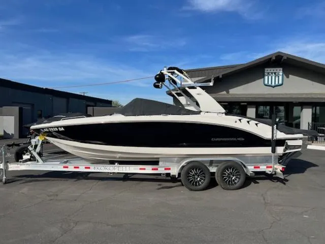 Slide: The Image of 2019 Chaparral 23 H2O Surf boat on trailer, parked outside a building. - 20