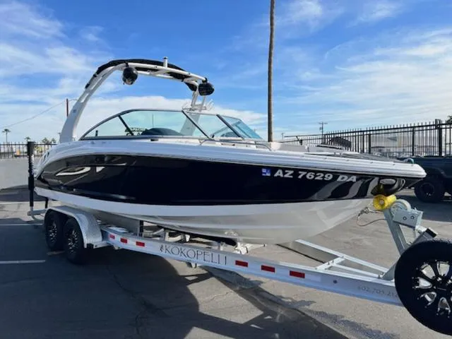 Slide: The Image of 2019 Chaparral 23 H2O Surf boat on trailer in parking lot. - 4