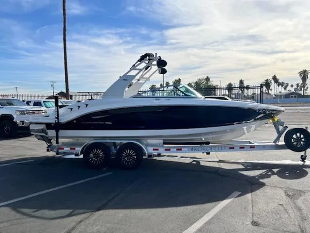 Slide: The Image of 2019 Chaparral 23 H2O Surf boat on trailer in parking lot. - 5