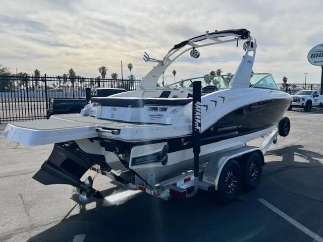 Slide: The Image of 2019 Chaparral 23 H2O Surf boat on trailer in parking lot. - 6