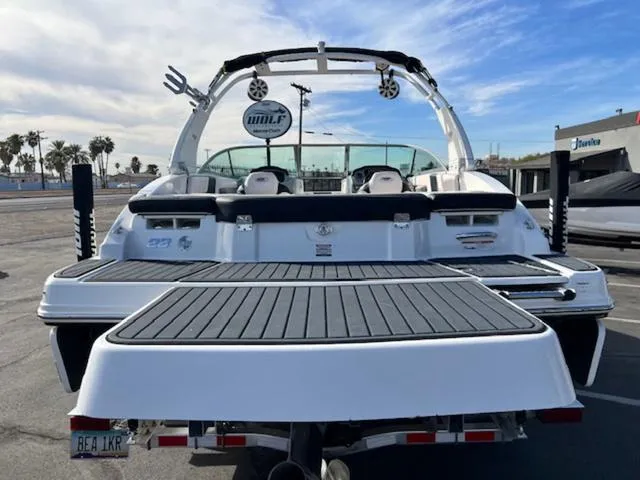 Slide: The Image of 2019 Chaparral 23 H2O Surf boat, rear view with swim platform and wakeboard tower. - 7