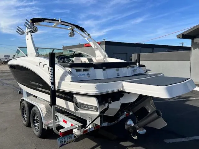 Slide: The Image of 2019 Chaparral 23 H2O Surf boat on trailer, parked outdoors. - 8
