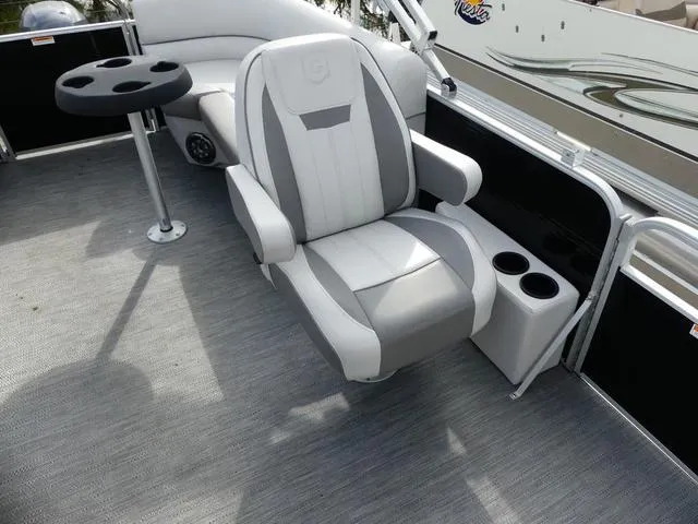 Slide: The Image of 2024 Godfrey Pontoons Sweetwater 2186 C interior with captain's chair and cup holders. - 12