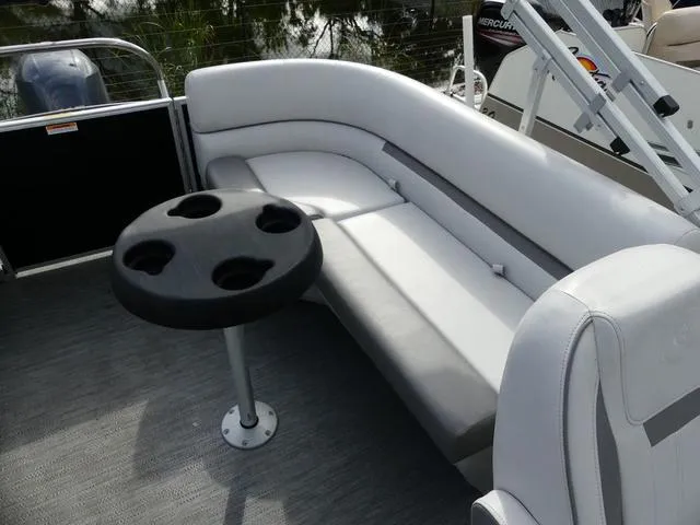 Slide: The Image of 2024 Godfrey Pontoons Sweetwater 2186 C interior with seating and cup holder table. - 13
