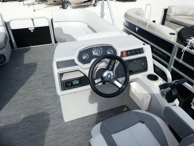 Slide: The Image of 2024 Godfrey Pontoons Sweetwater 2186 C helm with modern controls and seating. - 8