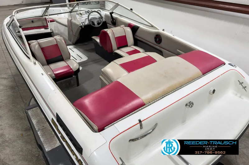 Slide: The Image of 1993 Bryant 200 boat interior with red and white seating, steering wheel, and dashboard. - 10