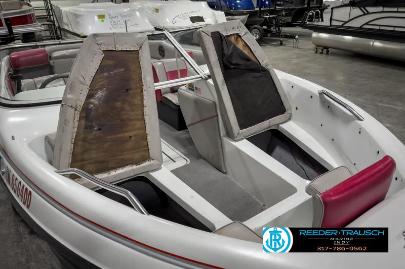 Slide: The Image of 1993 Bryant 200 boat interior with worn seats in a showroom. - 17