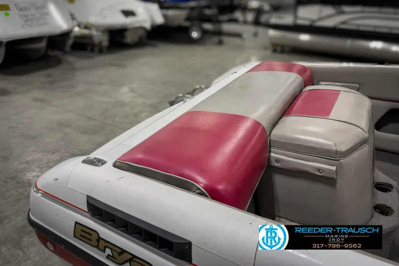 Slide: The Image of 1993 Bryant 200 boat interior with red and white seating in showroom. - 18