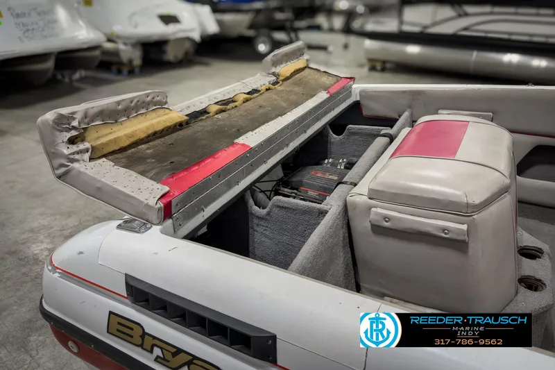 Slide: The Image of Open engine compartment of a 1993 Bryant 200 boat in a showroom. - 19