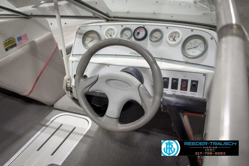 Slide: The Image of 1993 Bryant 200 boat dashboard with steering wheel and gauges. - 20