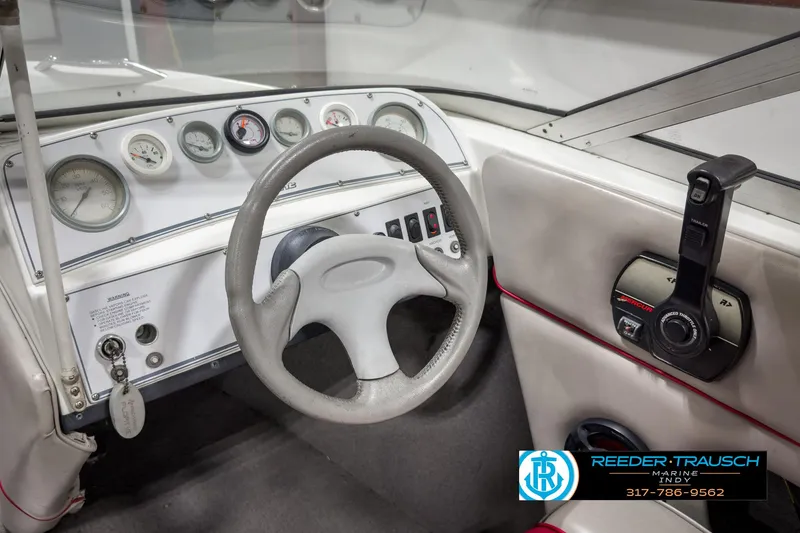 Slide: The Image of 1993 Bryant 200 boat dashboard with steering wheel and control panel. - 21
