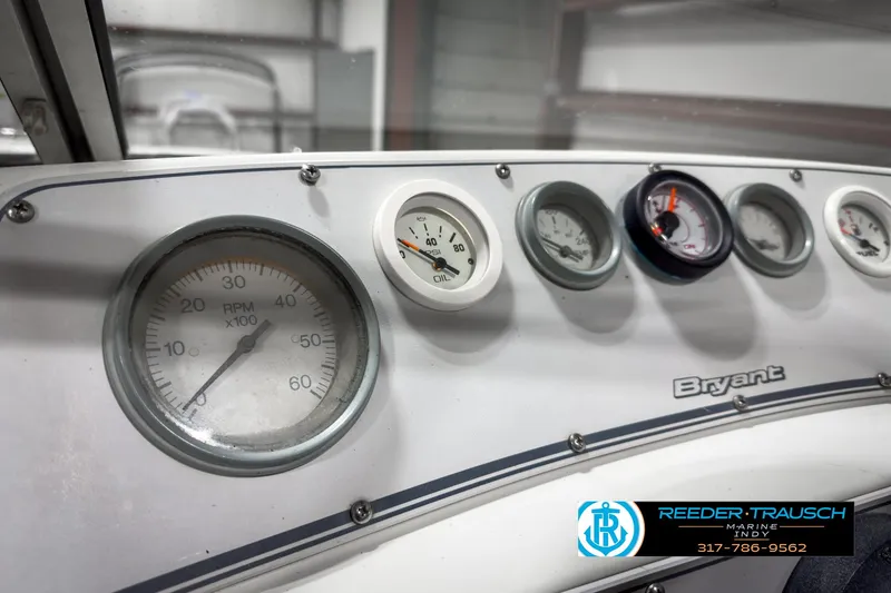 Slide: The Image of Dashboard of a 1993 Bryant 200 boat with various gauges and branding. - 22