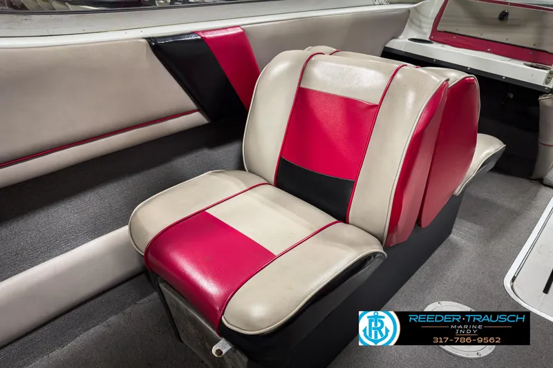 Slide: The Image of 1993 Bryant 200 boat interior with red, black, and beige seating. - 28