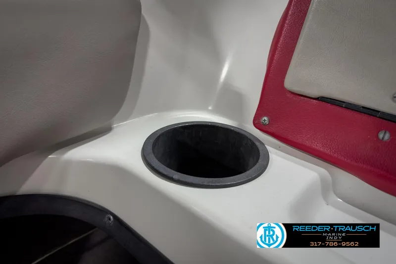 Slide: The Image of 1993 Bryant 200 boat interior with cup holder and red trim. - 29