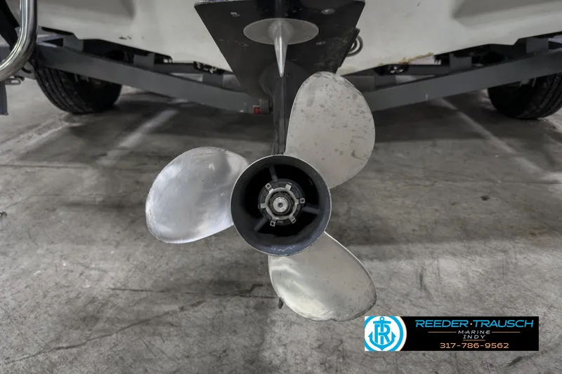 Slide: The Image of Close-up of a 1993 Bryant 200 boat propeller in a garage setting. - 36