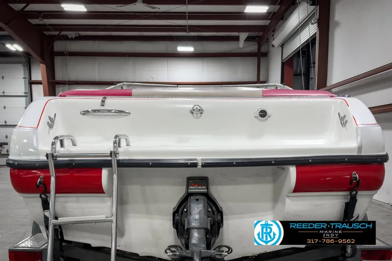 Slide: The Image of 1993 Bryant 200 boat in a garage, rear view with ladder and logo. - 5
