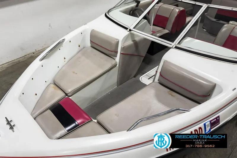 Slide: The Image of 1993 Bryant 200 boat interior with white and red seating, windshield, and logo. - 7