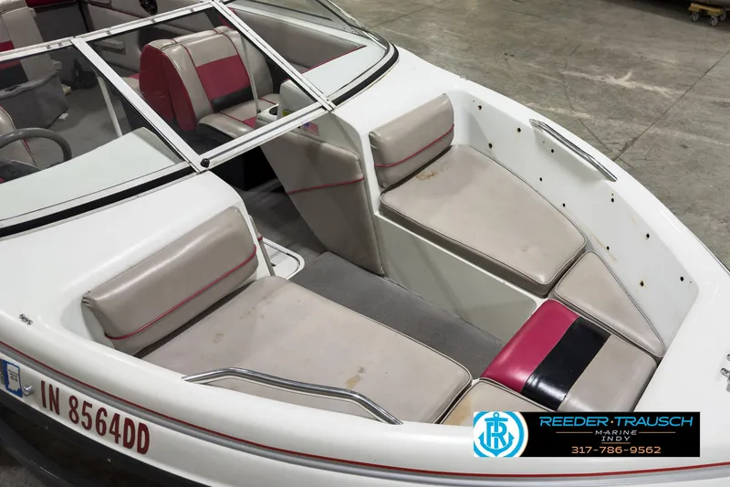 Slide: The Image of 1993 Bryant 200 boat interior with red and gray seating, Reeder-Trausch Marine logo visible. - 8
