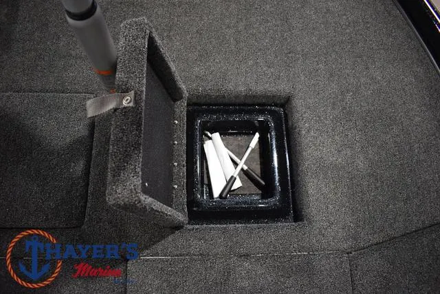 Slide: The Image of 2025 Nitro Z21 XL Pro boat storage compartment with open lid and rods inside. - 15