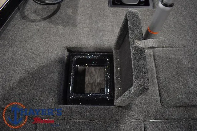 Slide: The Image of 2025 Nitro Z21 XL Pro boat storage compartment with open lid, gray carpet interior. - 16
