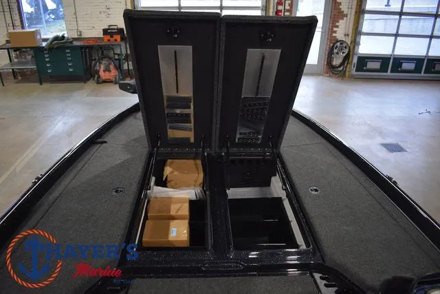 Slide: The Image of 2025 Nitro Z21 XL Pro boat storage compartments open in a workshop. - 20