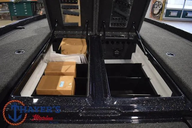 Slide: The Image of 2025 Nitro Z21 XL Pro boat storage compartments with boxes, Thayer's Marine logo visible. - 21
