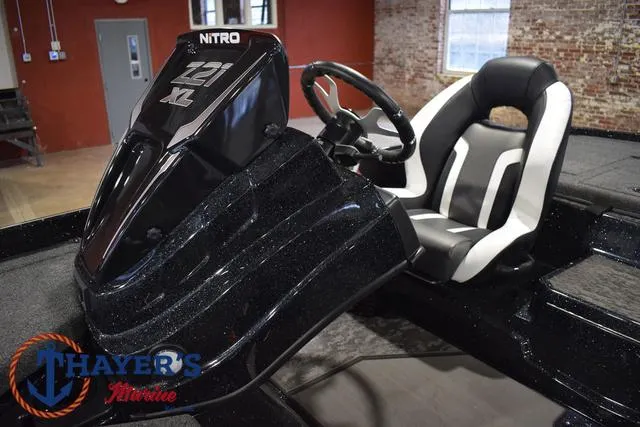 Slide: The Image of 2025 Nitro Z21 XL Pro boat interior with steering wheel and seat. - 28