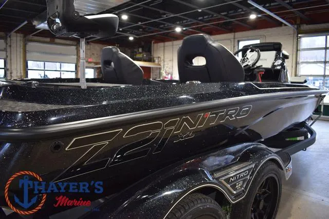 Slide: The Image of 2025 Nitro Z21 XL Pro boat in showroom, featuring sleek black design and modern seating. - 45