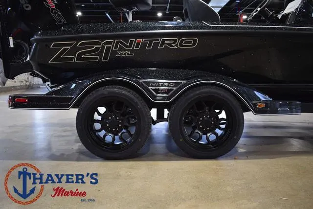 Slide: The Image of 2025 Nitro Z21 XL Pro boat trailer with dual black wheels at Thayer's Marine. - 5