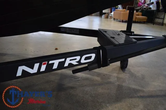 Slide: The Image of Nitro Z21 XL Pro 2025 boat trailer with logo in showroom setting. - 7