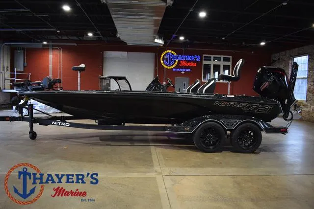 Slide: The Image of 2025 Nitro Z21 XL Pro boat displayed indoors at Thayer's Marine showroom. - 9