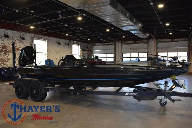 Slide: The Image of 2023 Blazer 625 Pro Elite boat displayed indoors at Thayer's Marine showroom. - 1