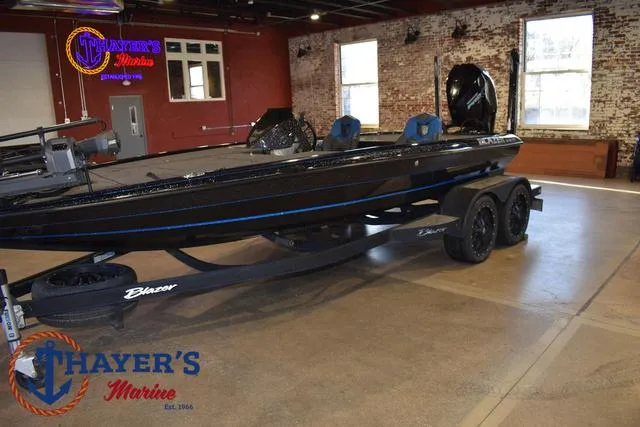Slide: The Image of 2023 Blazer 625 Pro Elite boat displayed indoors at Thayer's Marine showroom. - 11
