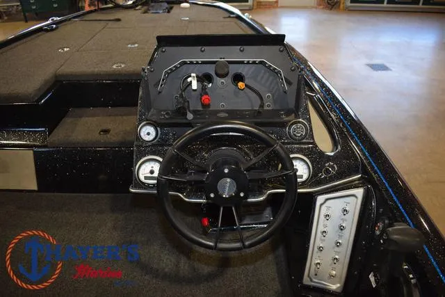 Slide: The Image of 2023 Blazer 625 Pro Elite boat dashboard with steering wheel and controls. - 18