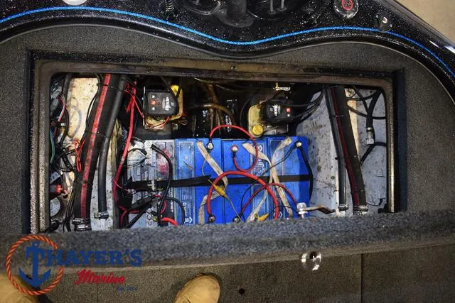 Slide: The Image of 2023 Blazer 625 Pro Elite boat battery compartment with wiring and components. - 19
