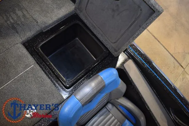 Slide: The Image of 2023 Blazer 625 Pro Elite boat interior with storage compartment and blue seat. - 21