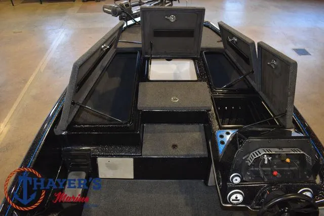 Slide: The Image of 2023 Blazer 625 Pro Elite boat interior with open storage compartments. - 28