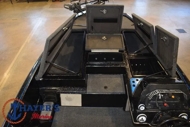 Slide: The Image of 2023 Blazer 625 Pro Elite boat interior with open storage compartments. - 29