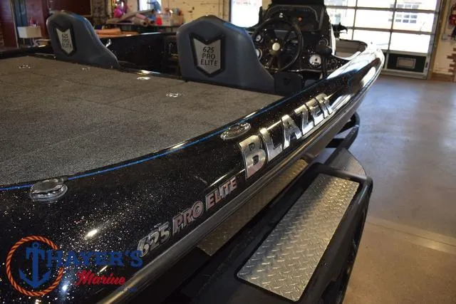Slide: The Image of 2023 Blazer 625 Pro Elite boat in showroom, featuring sleek design and branding. - 33