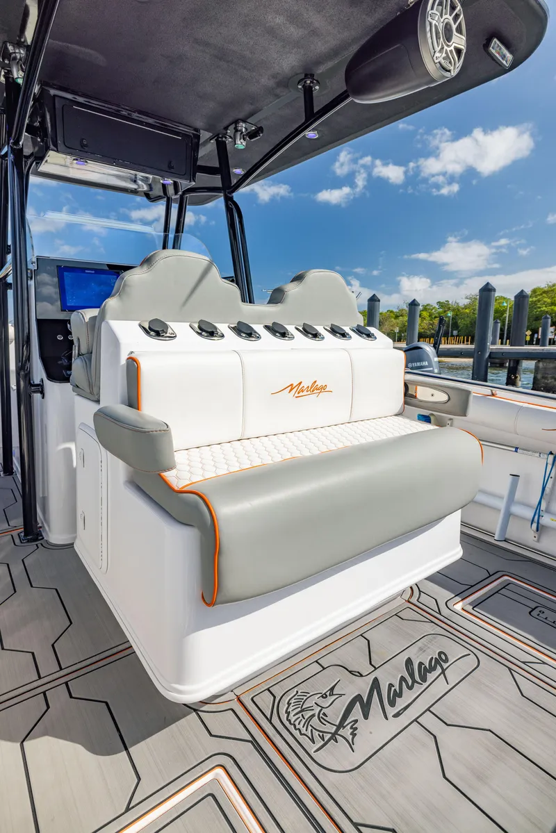 Slide: The Image of 2005 Marlago 35 boat interior with cushioned seating and modern design. - 13