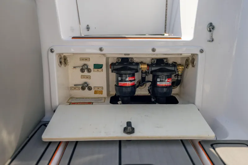 Slide: The Image of 2005 Marlago 35 boat fuel system compartment with dual filters and control switches. - 15