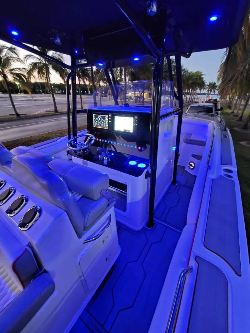 Slide: The Image of 2005 Marlago 35 boat interior with blue LED lighting and modern dashboard. - 17
