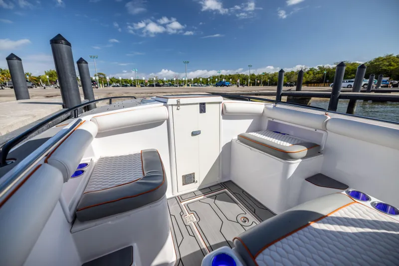 Slide: The Image of Interior of a 2005 Marlago 35 boat with cushioned seating and cup holders. - 5