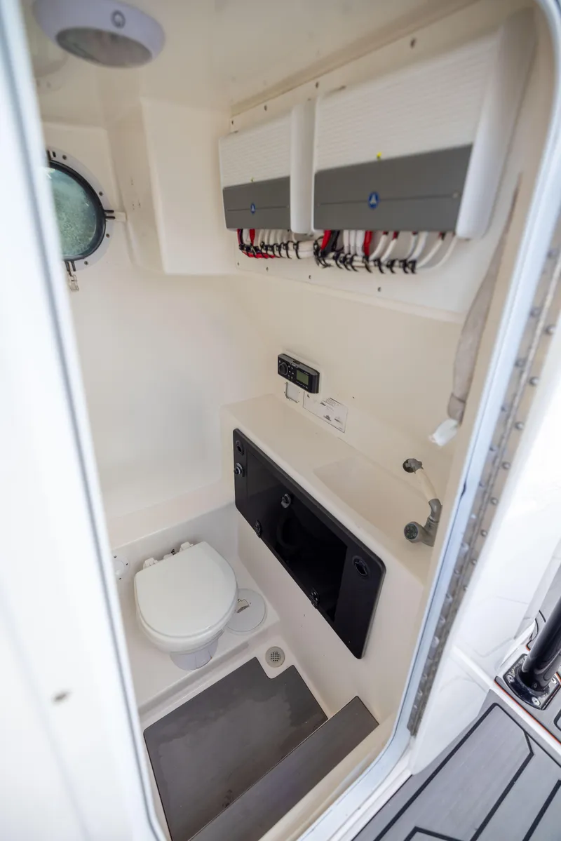 Slide: The Image of 2005 Marlago 35 boat interior with toilet and control panels. - 8