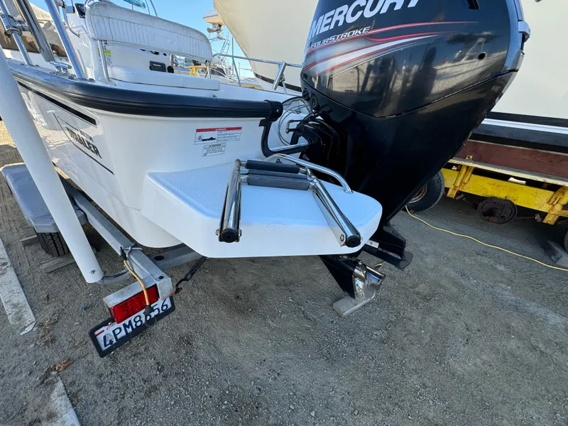 Slide: The Image of 2016 Boston Whaler 170 MONTUCK boat with Mercury engine, parked on a trailer. - 10